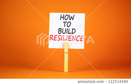 How to build resilience symbol. Concept words How to build resilience on beautiful white paper on clothespin. Beautiful orange background. Business and how to build resilience concept. Copy space 122514390