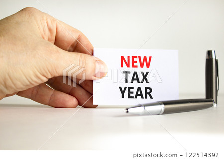 New tax year symbol. Concept words New tax year on beautiful white card. Beautiful white background. Businessman hand. Business new tax year concept. Copy space. 122514392