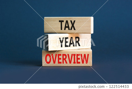 Tax year overview symbol. Concept words Tax year overview on beautiful wooden blocks. Beautiful grey table grey background. Business tax year overview concept. Copy space. Tax year overview symbol. Concept words Tax year overview on beautiful wooden blocks. Beautiful grey table grey background. Business tax year overview concept. Copy space. 122514433