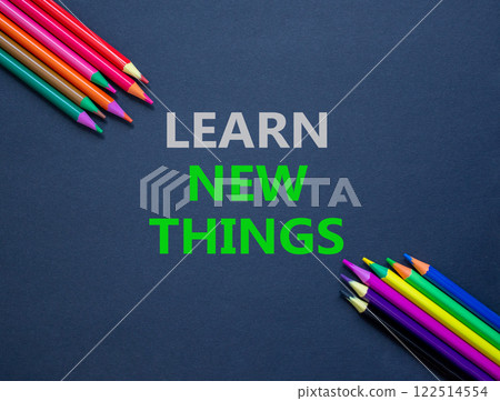 Learn new things symbol. Concept words Learn new things on beautiful grey paper. Beautiful grey paper background. Colored pencils. Business motivational learn new things concept. Copy space. 122514554