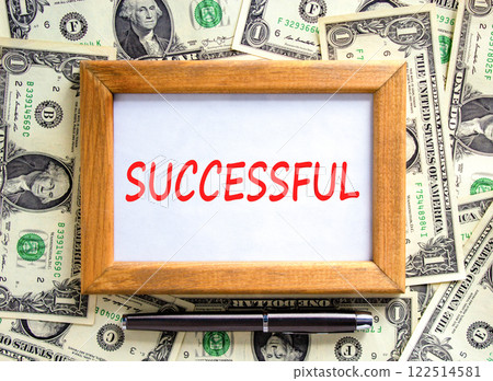 Successful symbol. Concept word Successful on beautiful wooden picture frame. Beautiful dollar bills background. Dollar bills. Black pen. Business successful concept. Copy space. Successful symbol. Concept word Successful on beautiful wooden picture frame. Beautiful dollar bills background. Dollar bills. Black pen. Business successful concept. Copy space. 122514581