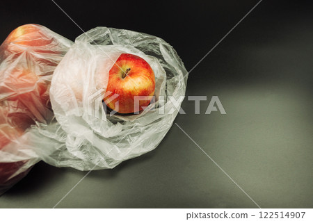 A plastic bag with an apple inside A plastic bag with an apple inside 122514907