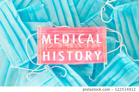 A blue and pink medical history sign is on top of a pile of blue A blue and pink medical history sign is on top of a pile of blue 122514912