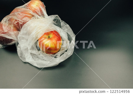 A plastic bag with an apple inside A plastic bag with an apple inside 122514956