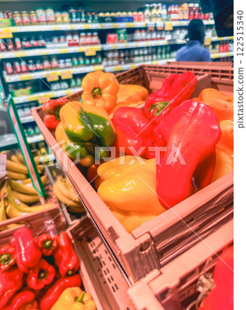 Large fresh red and yellow bell pepper in the supermarket 122515340