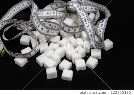 Cubes of white refined sugar on a black background 122515380