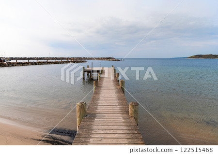 Long wooden pier on the sea. Landscape view. Long wooden pier on the sea. Landscape view. 122515468