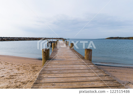 Long wooden pier on the sea. Landscape view. 122515486