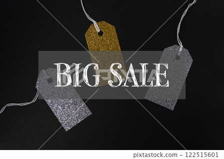 Three tags with gold and silver glitter are hanging Three tags with gold and silver glitter are hanging 122515601