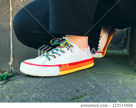 Person is sitting on the ground with their feet up 122515698