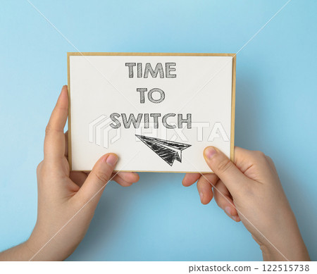 A hand holding a piece of paper with the words Time to Switch written on it A hand holding a piece of paper with the words Time to Switch written on it 122515738