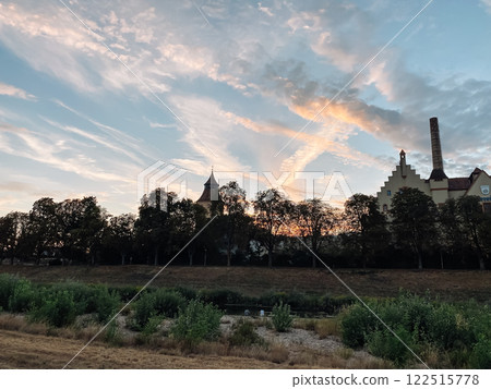Beautiful sunset over a city with a large building in the background 122515778