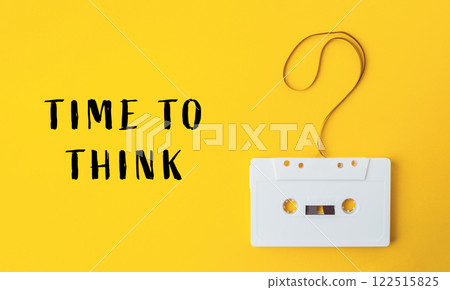 White cassette tape is hanging from a string with a question mark on it White cassette tape is hanging from a string with a question mark on it 122515825