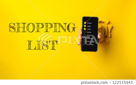 Person holding a cell phone with a shopping list written on it 122515843