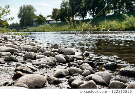 Rocky shoreline with a body of water in the background 122515856