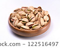 Pistachios in a wooden bowl on a white background 122516497