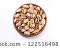 Pistachios in a wooden bowl, photographed from directly above 122516498