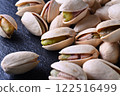 Pistachios on a slate plate 122516499