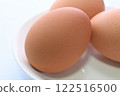 Red egg, brown egg, one close-up 122516500