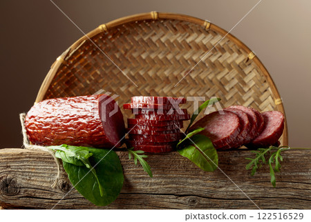 Sliced salami on a old wooden board. Sliced salami on a old wooden board. 122516529