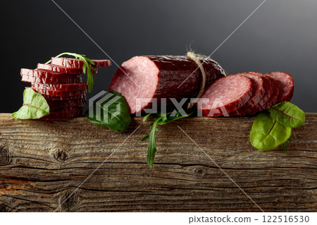 Sliced salami on a old wooden board. Sliced salami on a old wooden board. 122516530