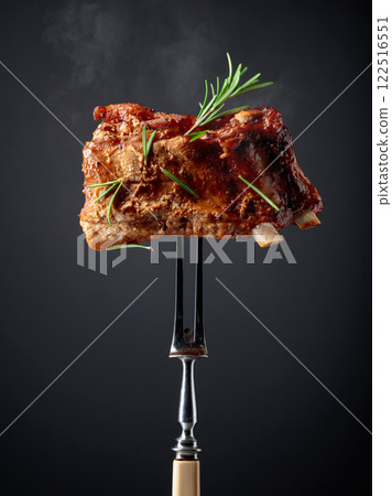 Grilled pork ribs on a fork. 122516551