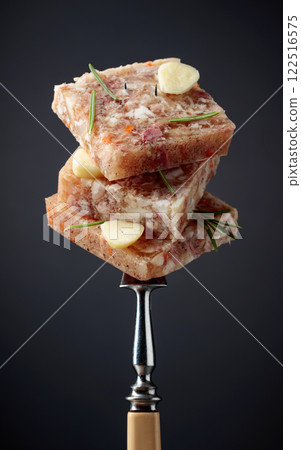 Headcheese on a fork. 122516575