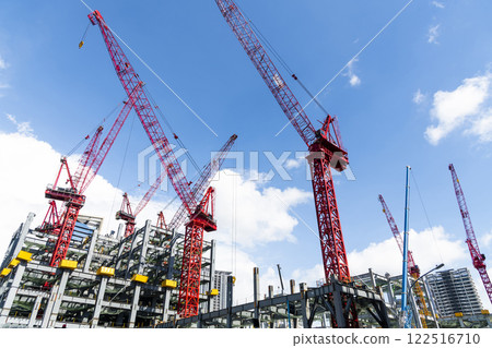 Low-angle view of cranes and steel structures of building construction with a blue sky background in Taiwan. 122516710