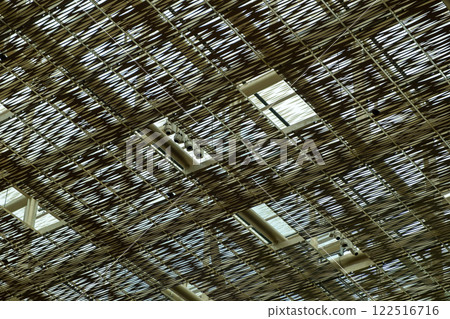 Decorative metal ceiling or roof structure featuring an intricate, crisscross pattern of thin metallic strips Decorative metal ceiling or roof structure featuring an intricate, crisscross pattern of thin metallic strips 122516716