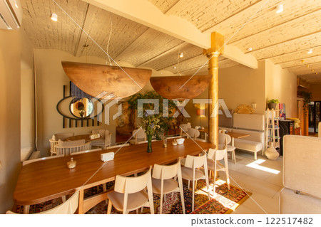 The inviting interior of a coffee shop adorned with warm colors 122517482