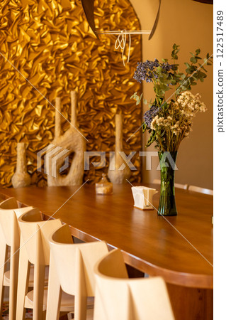 The inviting interior of a coffee shop adorned with warm colors 122517489