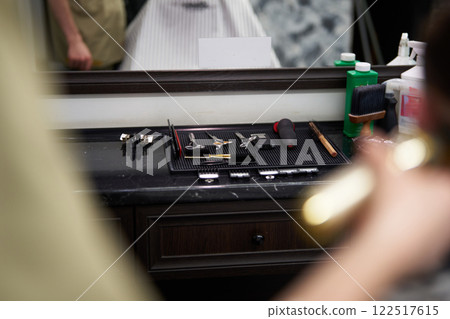 Barber tools neatly arranged on a counter in a grooming salon 122517615