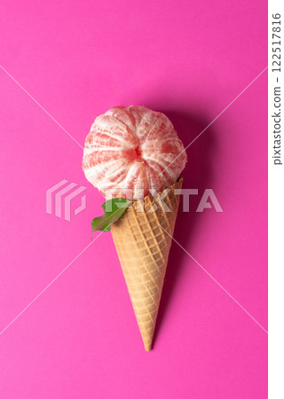 Grapefruit Ice Cream in a Cone on Pink Background Grapefruit Ice Cream in a Cone on Pink Background 122517816
