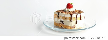 Delicious layered cake with frosting and strawberry served on a glass plate in a bright kitchen setting 122518145