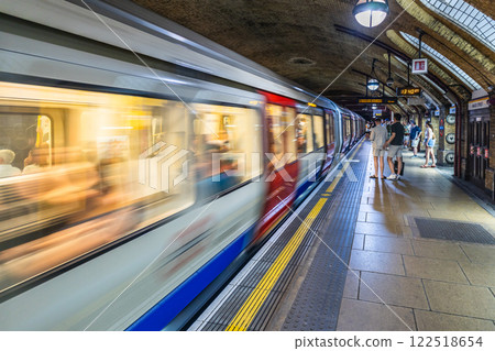 Motion Blur of London Underground Train in Action at Busy Station Motion Blur of London Underground Train in Action at Busy Station 122518654