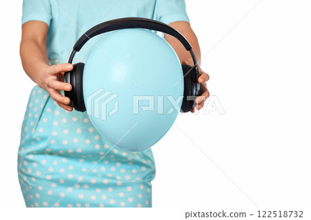 Female hand holding blue balloon with headphones on white background 122518732