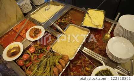 A Culinary Array of Traditional Turkish Dishes, Meats, Vegetables, and White Rice 122518891