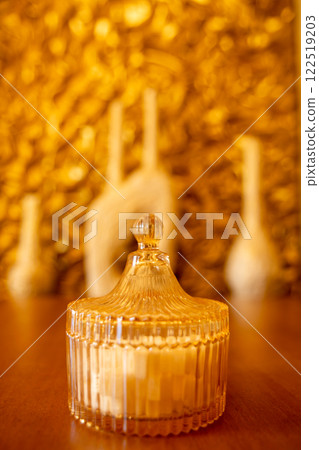 A charming sugar bowl sits on a cafe table bathed in warm morning light 122519203