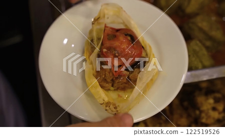 Close-Up of Delicious Turkish Baked Meat with Tomato and Olives on a White Plate 122519526