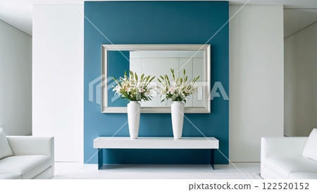 Modern living room with white sofas and a blue accent wall, featuring elegant flower arrangements in vases and a large decorative mirror above a sleek console table Modern living room with white sofas and a blue accent wall, featuring elegant flower arrangements in vases and a large decorative mirror above a sleek console table 122520152