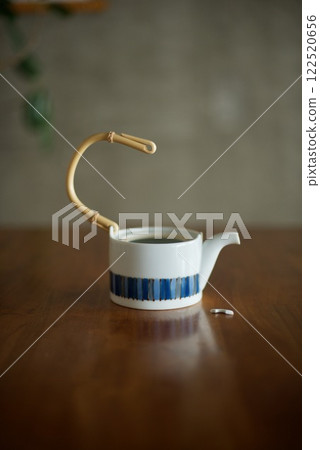 A ceramic teapot with a broken handle A ceramic teapot with a broken handle 122520656