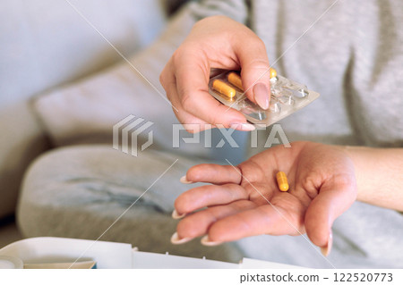 Woman is going to take medicine for headache, stomach or vitamin and food supplements. Woman is going to take medicine for headache, stomach or vitamin and food supplements. 122520773