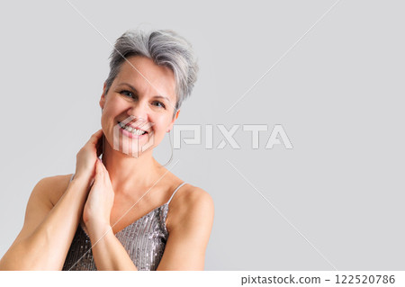 Beautiful happy middle-aged elderly woman with gray short hair smiling and looking at camera. 122520786