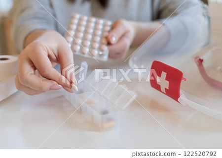 A woman takes her daily sedative or medicine for a headache or stomach pain. A woman takes her daily sedative or medicine for a headache or stomach pain. 122520792