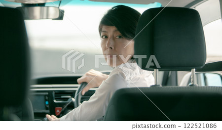 A woman in her 50s holding the wheel 122521086