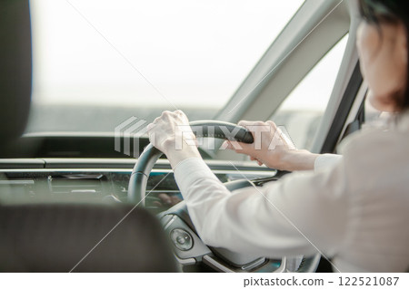 A woman in her 50s holding the wheel 122521087