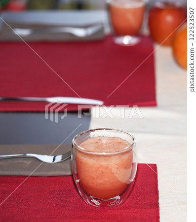 A glass of fresh juice on table. Healthy food. A glass of fresh juice on table. Healthy food. 122523507