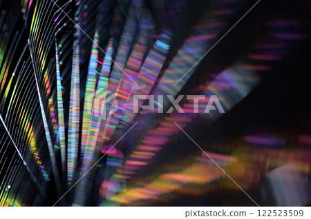 A close-up of a spider web shining iridescently in the morning sun A close-up of a spider web shining iridescently in the morning sun 122523509