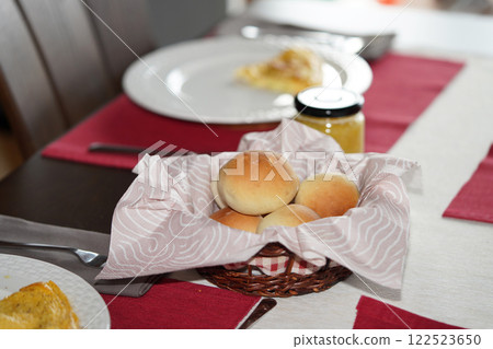 Fresh bread bunchs in basket on table. Breakfast at home. 122523650