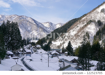 Morning in a snowy mountain and rural village in winter Morning in a snowy mountain and rural village in winter 122523705